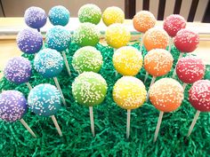 cake pops with sprinkles on top of green grass