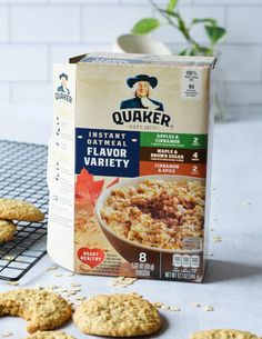 a box of oatmeal sitting on top of a table next to cookies