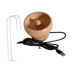 a wooden bowl sitting on top of a charger next to a usb cable and plugged in