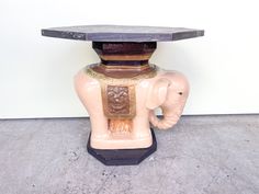 an elephant statue with a table top on it's back