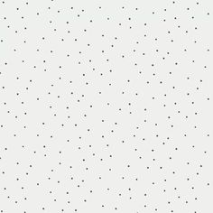 a white wall with black dots on it