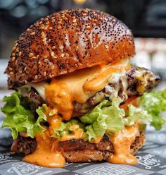 a cheeseburger with lettuce and other toppings