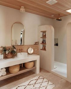 a bathroom with a sink, mirror and bathtub next to a walk in shower