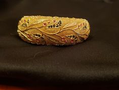 "This is a beautifully etched vintage gold plated bracelet. I would describe it as a wide bangle. On the top it is 2 3/8\" and the bottom it narrows to 1 1/4\". The etching on top is a floral/leaf design adorned with faux stones. The gold has a pattern design as well like a hammered textured look but it is smooth on the bottom. Total weight is almost 3 oz solid. It has a box clasp and would make a great gift for yourself or mom! It's about 7.5\" round." Bracelet I, Box Clasp, Faux Stone, Gold Plated Bracelets, Gold Fashion, Sapphire Diamond, Leaf Design, Vintage Gold, Etching