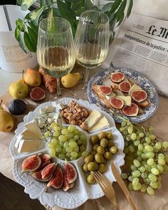 a table topped with plates of food and glasses of wine