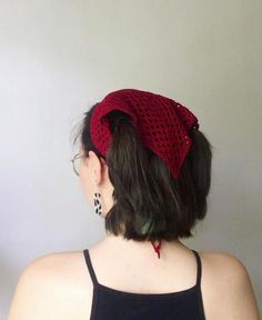 a woman wearing a red knitted headband