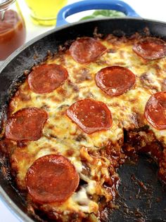 a pepperoni pizza sitting on top of a pan with one slice missing from it