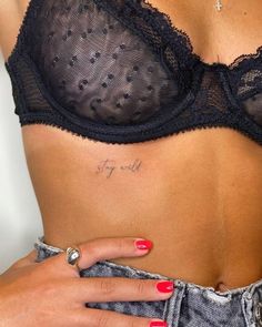 a woman's stomach with a small tattoo on it