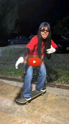 a woman riding a skateboard on top of a sidewalk