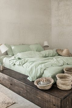 a bed sitting on top of a wooden platform next to a lamp and basket filled with eggs