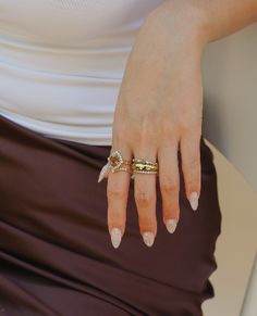 a woman's hand with two rings on it