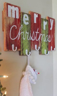 a christmas sign hanging from the side of a wall