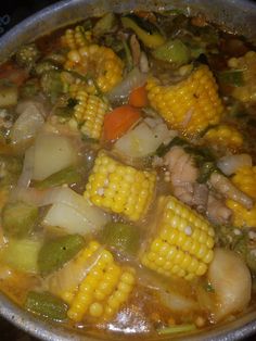 a pot filled with soup and vegetables on top of a stove