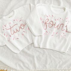 Beautiful hand embroidered ONE chunky sweater. Perfect for your baby's first birthday.  This listing is for one sweater only. You pick the wording from 1/2, ONE, or TWO White Sweater and pink lettering plus sprinkles as pictured. If you want a different color, just send us a convo. We'll be happy to customize for you Hand embroidery on a chunky sweater True to size Custom orders welcome Cute Crew Neck Birthday Sweater, Cute Crew Neck Sweater For Birthday, Long Sleeve Tops With Letter Embroidery For Birthday, White Tops For Birthday And Winter, White Top For Birthday In Winter, Cute Sweater For Birthday In Winter, Personalized White Sweater For Winter, Embroidered Winter Birthday Sweater, Hand Embroidered Sweater