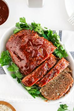 meatloaf with sauce and parsley in a white bowl