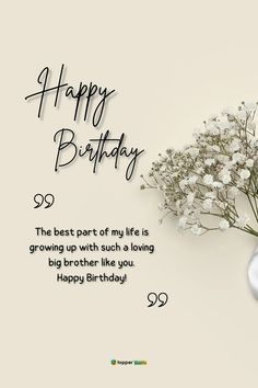 a vase filled with white flowers sitting on top of a table next to a happy birthday card