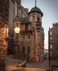 an old stone building with a light on