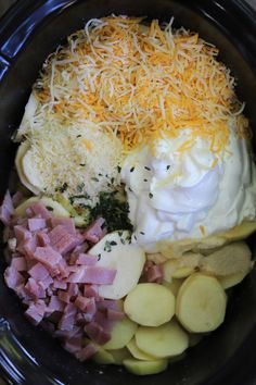 an assortment of food in a crock pot with cheese and other toppings on top