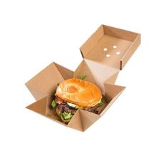 an open cardboard box with a hamburger in it on top of another one that is inside