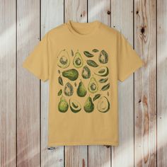 Block Print Avocado Comfort Colors Cotton T-Shirt - Featuring a charming block print avocado design, the whimsical print design adds a touch of fun and flair to your wardrobe, making it the perfect choice for avocado enthusiasts and foodies everywhere. 🥑 Wear Your Love for Avocado 🥑 Whether you're brunching with friends, hitting the farmers' market, or simply expressing your love for all things avocado, this t-shirt is the perfect companion. Let your style reflect your passion for this delicious fruit with our block print avocado design. Indulge in the whimsy of avocado love with our Block Print Avocado Comfort Colors Cotton T-Shirt. Order yours today and let your style be as delicious as your favorite snack.  .: Made with medium weight fabric consisting of high quality, 100% ring-spun U Organic Green Short Sleeve Top, Cute Printed Green T-shirt, Cute Green Printed T-shirt, Green Graphic Tee With Fruit Print, Cute Green Top With Fruit Print, Avocado Design, Comfort Colors Shirt, Delicious Fruit, Favorite Snack