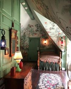 an attic bedroom with green walls and floral wallpaper