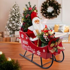 a santa clause sitting in a sleigh with christmas decorations