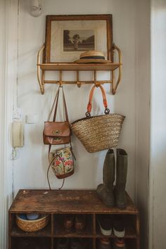 an entryway with shoes and purses hanging on the wall