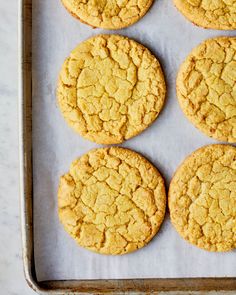 six cookies on a baking sheet ready to be baked in the oven for dinner or dessert