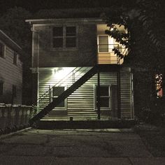 an apartment building with stairs lit up at night