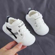 Style and comfort, perfect for your baby's first steps! These lightweight sneakers feature flexible soles, velcro straps, and a minimalist design. With a variety of colorways to choose from, your baby will love these shoes! Unisex Upper Material: PU Outsole Material: Rubber Closure Type: Velcro Slip-resistant Round Toe Sneakers For Playtime, Breathable Sneakers With Round Toe For Playtime, Breathable Round Toe Sneakers For Playtime, White Slip-resistant Sneakers For Playtime, White Scratch-resistant Sneakers For Playtime, Slip-on Sneakers With Soft White Sole, White Slip-resistant Canvas Shoes With Round Toe, White Closed Toe Sneakers With Soft Sole, Baby's First Step