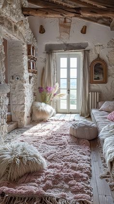 a living room filled with lots of furniture and pillows on top of a pink rug