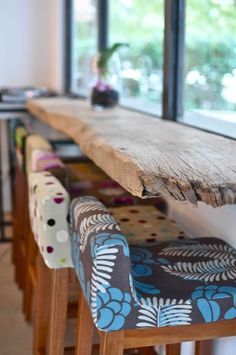 several stools are lined up in front of a window