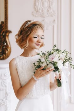 a woman in a wedding dress holding a bouquet