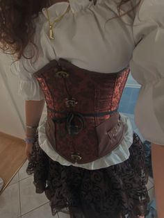 a woman is wearing a corset and skirt