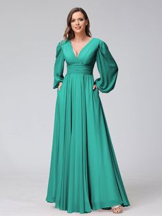 a woman wearing a long green dress with puff sleeves and a v - neckline