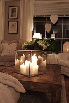 a coffee table with candles on it in a living room