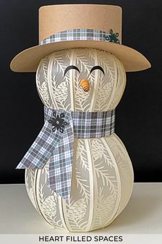 a paper snowman with a hat and scarf