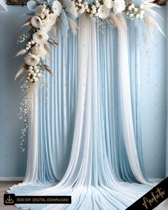 a blue and white wedding backdrop with flowers on the top is featured in this image