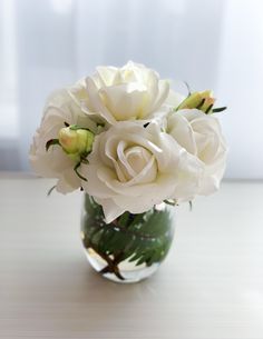 a vase filled with white flowers on top of a table