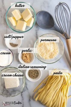 the ingredients to make pasta laid out on a marble counter top, including butter, garlic, parmesan cheese and seasoning