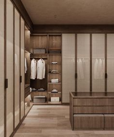 an empty walk in closet with clothes hanging on the walls and wooden flooring,