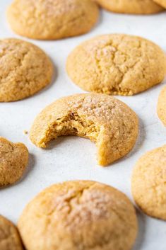 a cookie with a bite taken out of it sitting on top of a baking sheet