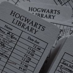 two harry potter library id cards sitting on top of each other