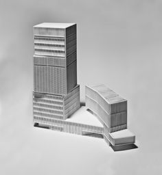 two tall buildings sitting next to each other on top of a white floor covered in snow