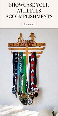 a rack with medals hanging from it and the words show case your athletes'accomplishments