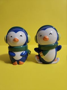 two small penguin figurines sitting next to each other