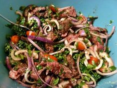 a blue bowl filled with meat and veggies