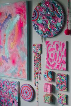 the wall is covered with colorful art and crafts, such as paper plates, magnets, and beads