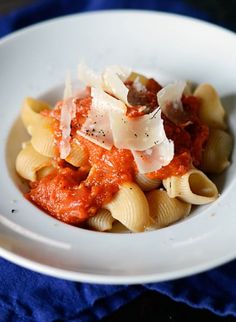 a white bowl filled with pasta and sauce