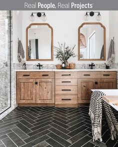 a bathroom with two sinks and mirrors on the wall